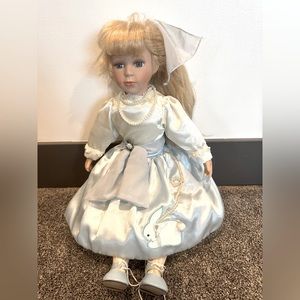 Porcelain doll with blue bunny hop skirt